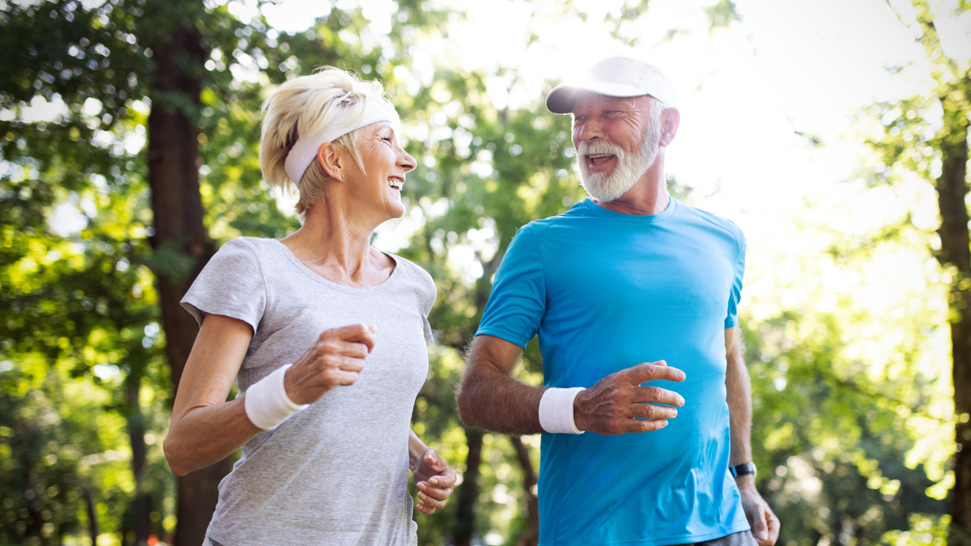 A man and a woman are jogging in a park.