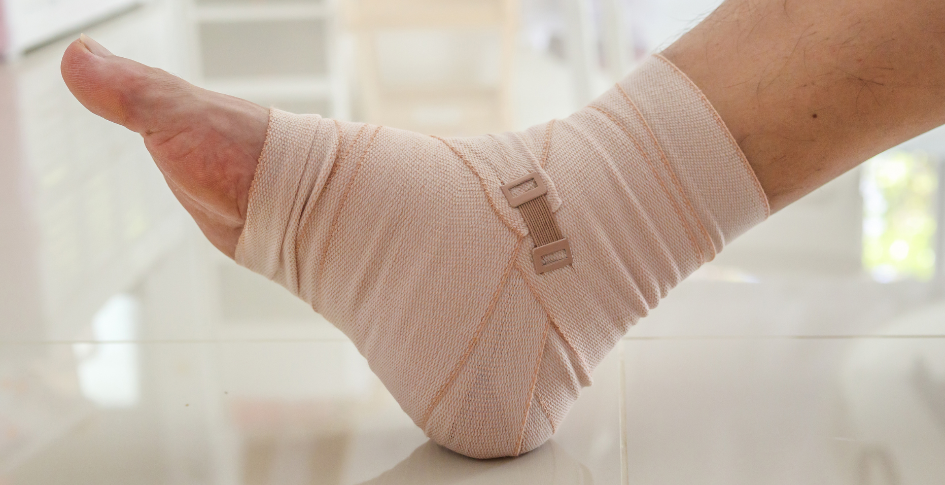 A close up of a person 's foot with a bandage on it.