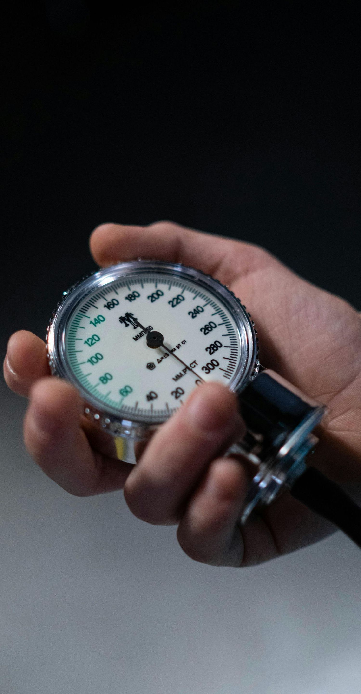 A person is holding a pressure gauge in their hand.