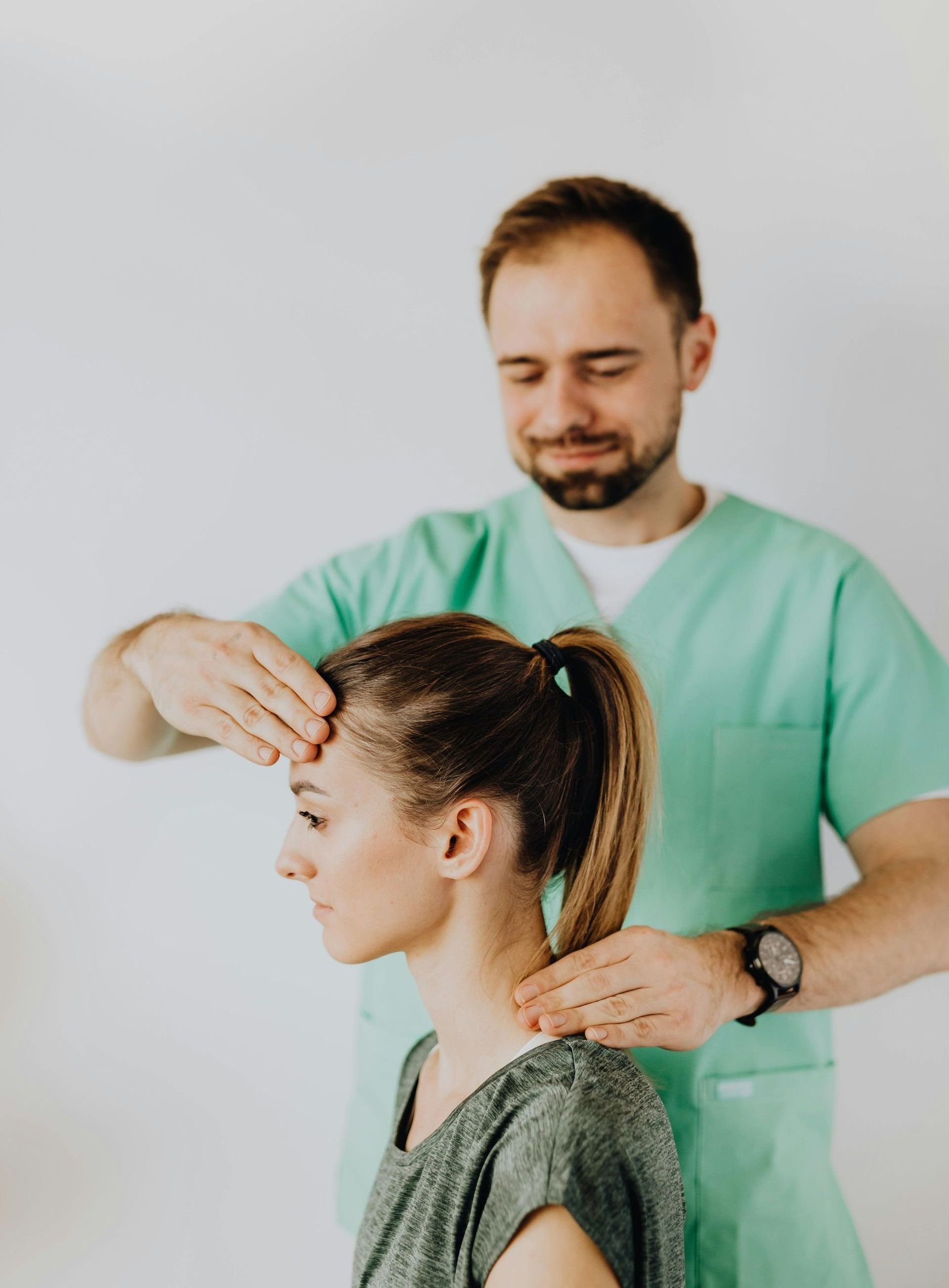 a nurse touching a woman's forehead