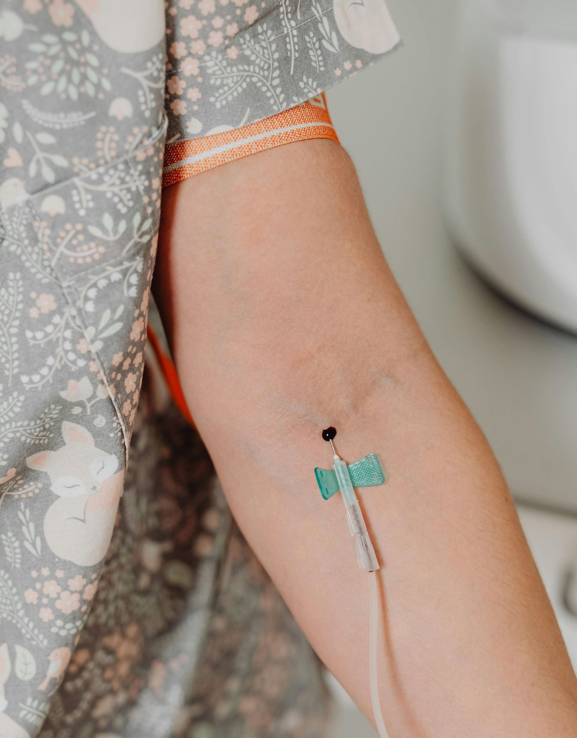A close up of a person 's arm with an iv in it.
