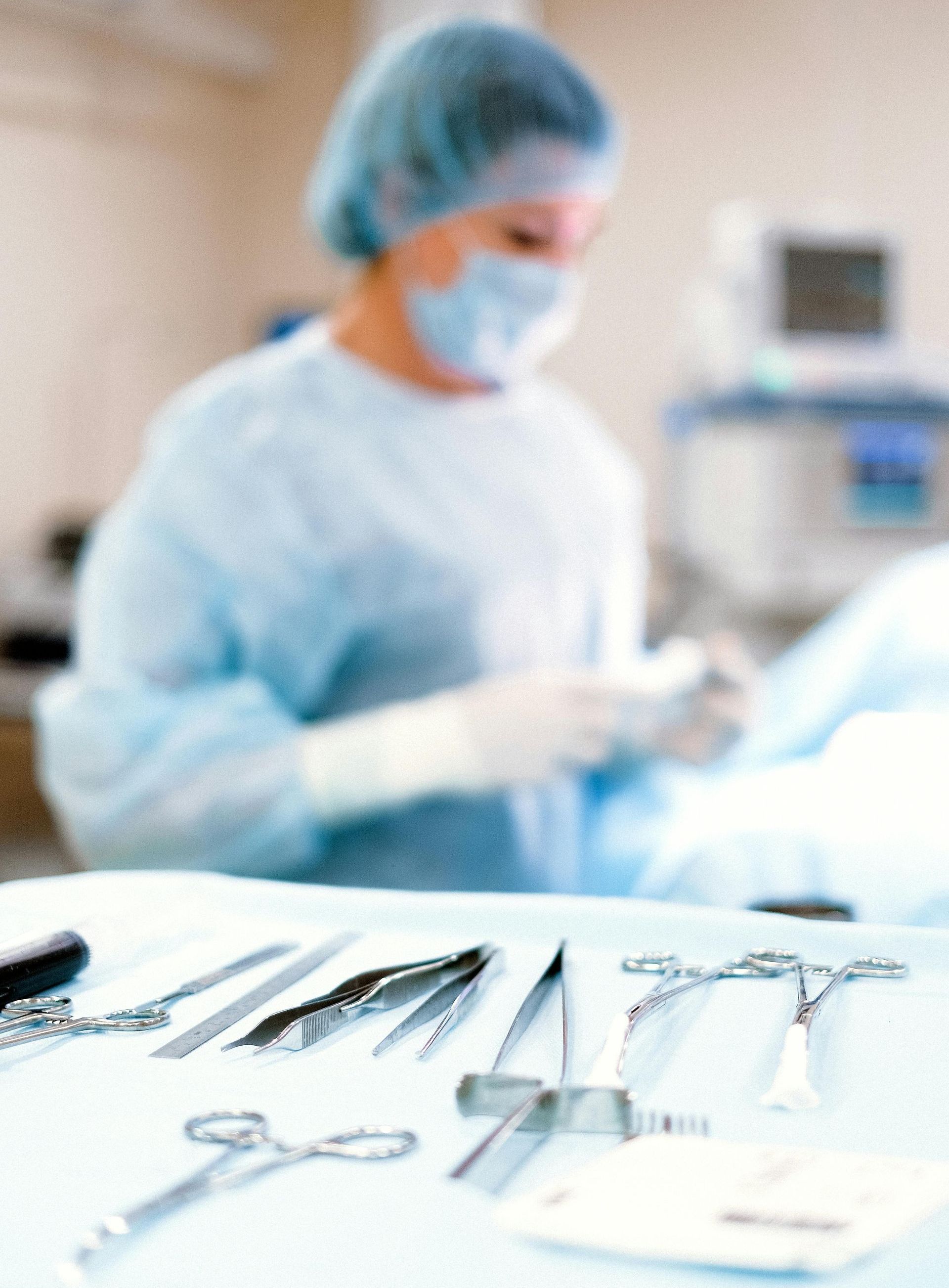 A blurred image of a surgeon in an operating room