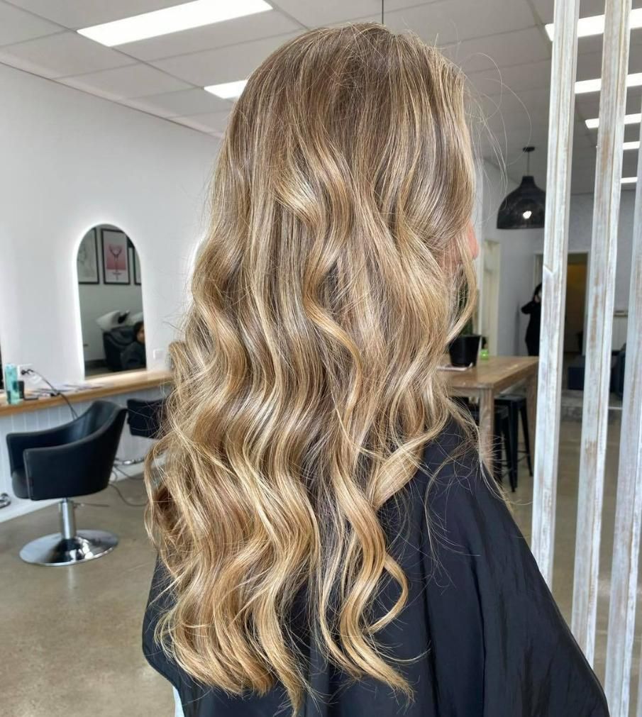 A Woman with Long Blonde Hair Is Getting Her Hair Done — Eden Hair in Pacific Paradise, QLD