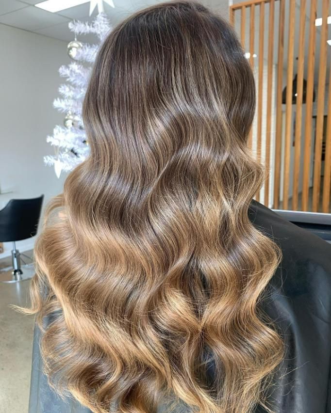 A Woman with Long Wavy Hair — Eden Hair in Pacific Paradise, QLD