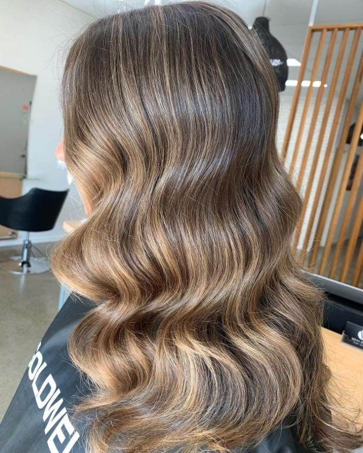 A Woman with Long Wavy Hair — Eden Hair in Pacific Paradise, QLD