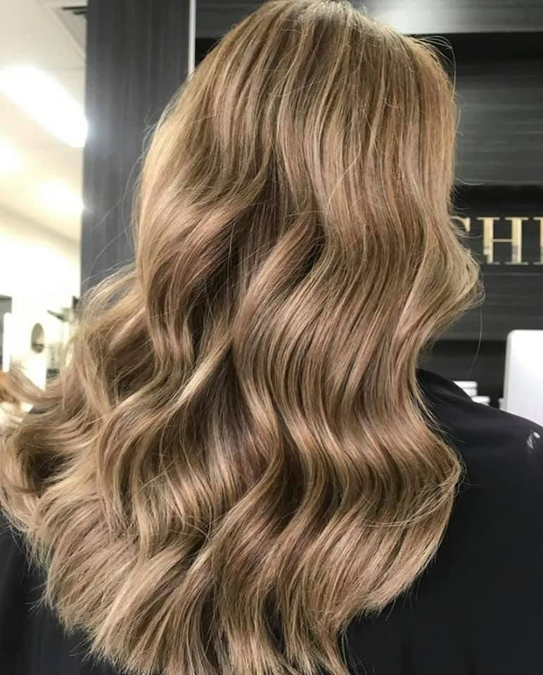 A Woman with Long Wavy Blonde Hair — Eden Hair in Pacific Paradise, QLD
