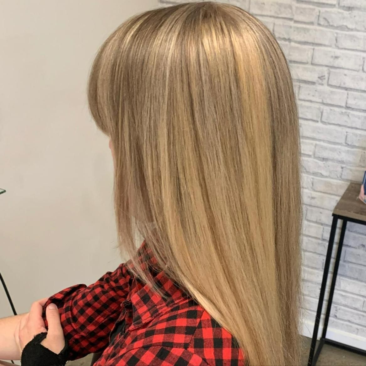 A Woman with Long Blonde Hair Is Wearing a Plaid Shirt — Eden Hair in Pacific Paradise, QLD