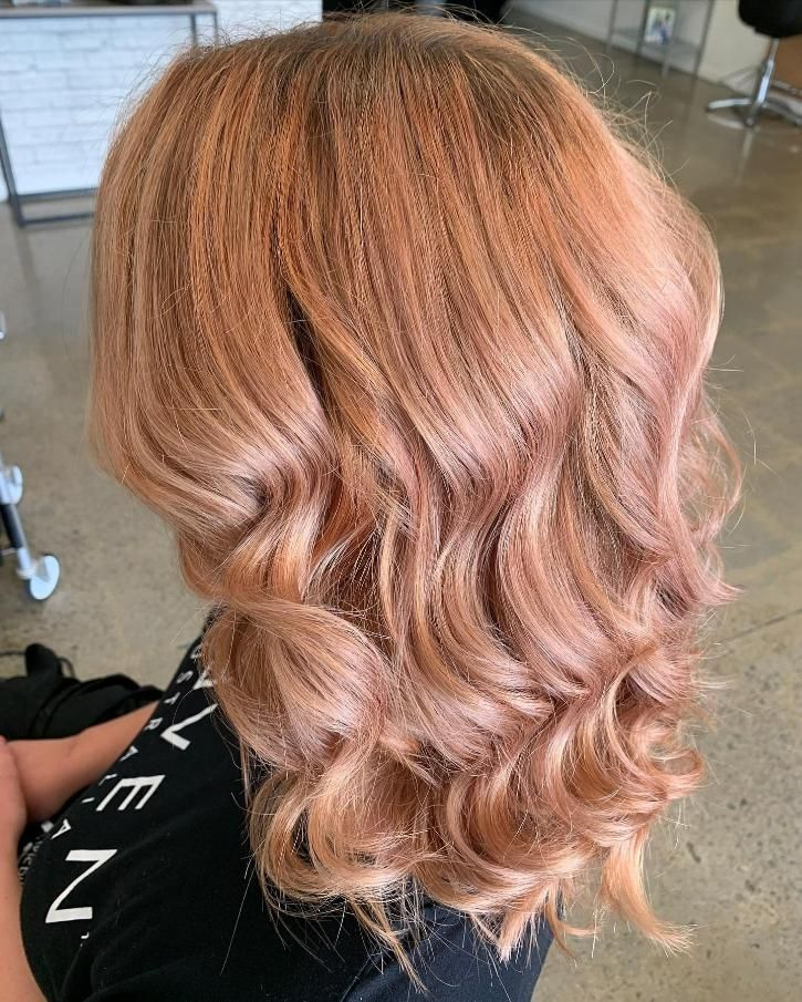 A Woman with Blonde Hair Is Sitting in A Chair in A Salon — Eden Hair in Pacific Paradise, QLD