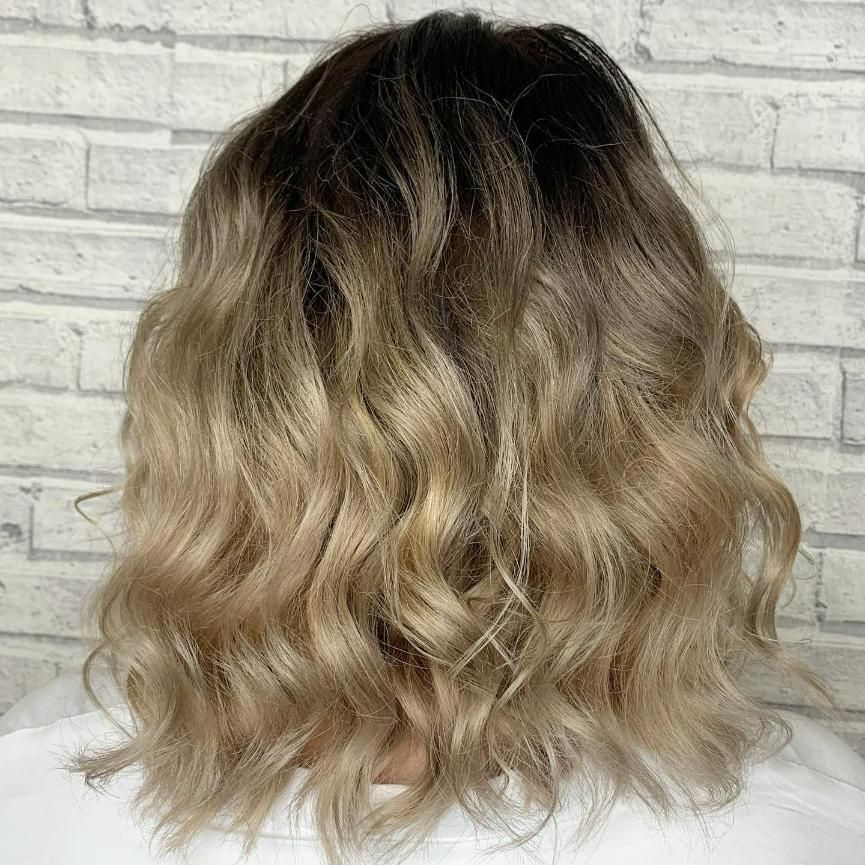 A Woman with Blonde Hair Is Standing — Eden Hair in Pacific Paradise, QLD