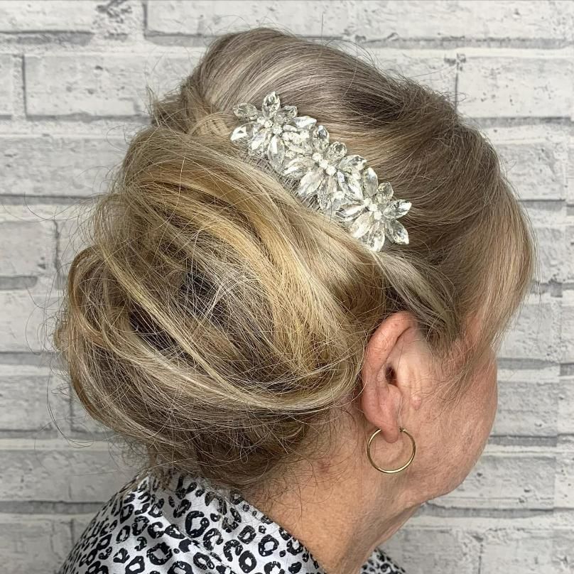 Woman with blond updo hairstyle, adorned with crystal hair comb, wearing hoop earrings — Eden Hair in Pacific Paradise, QLD