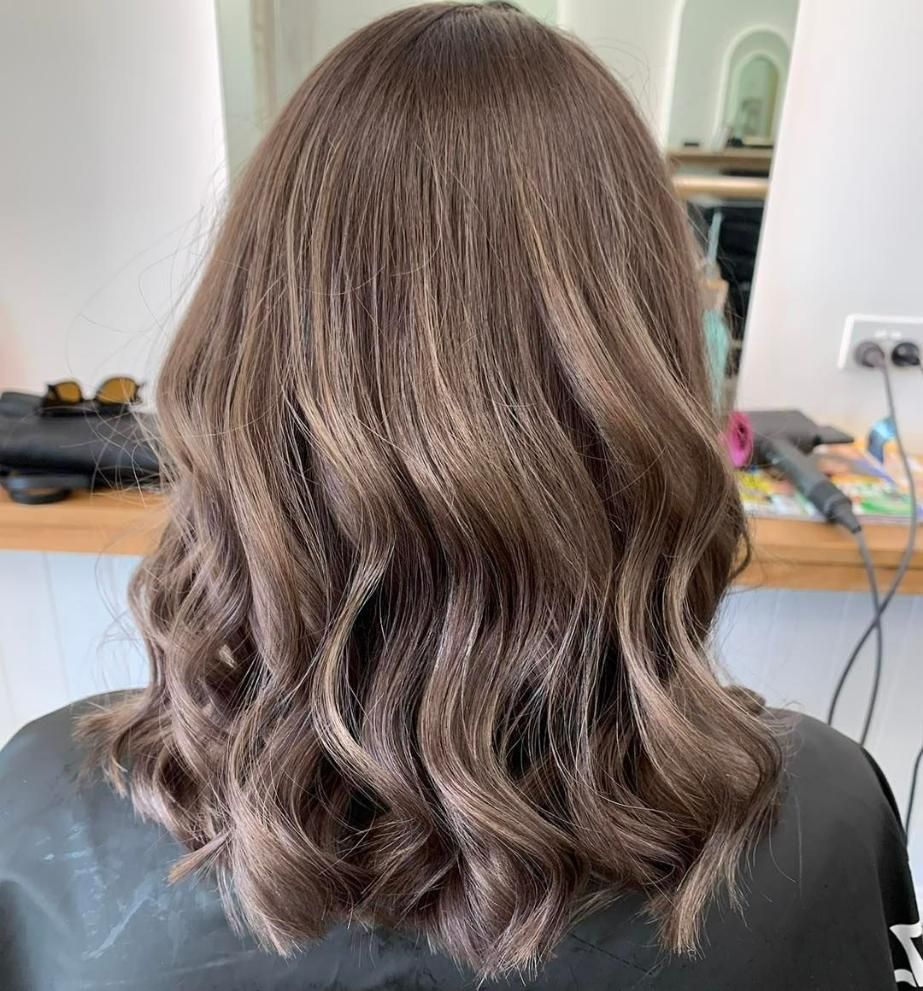 A Woman with Long Brown Hair — Eden Hair in Pacific Paradise, QLD