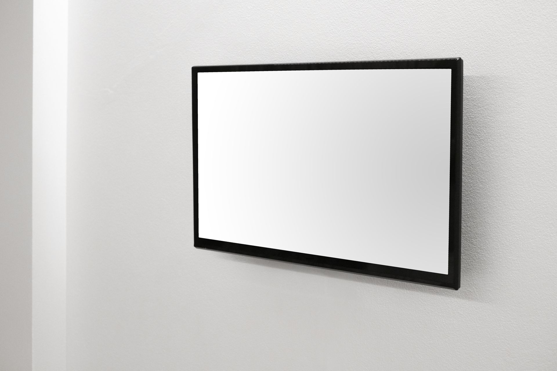 Futuristic exhibition highlighting interactive flat panel display on vertical blank digital wall.