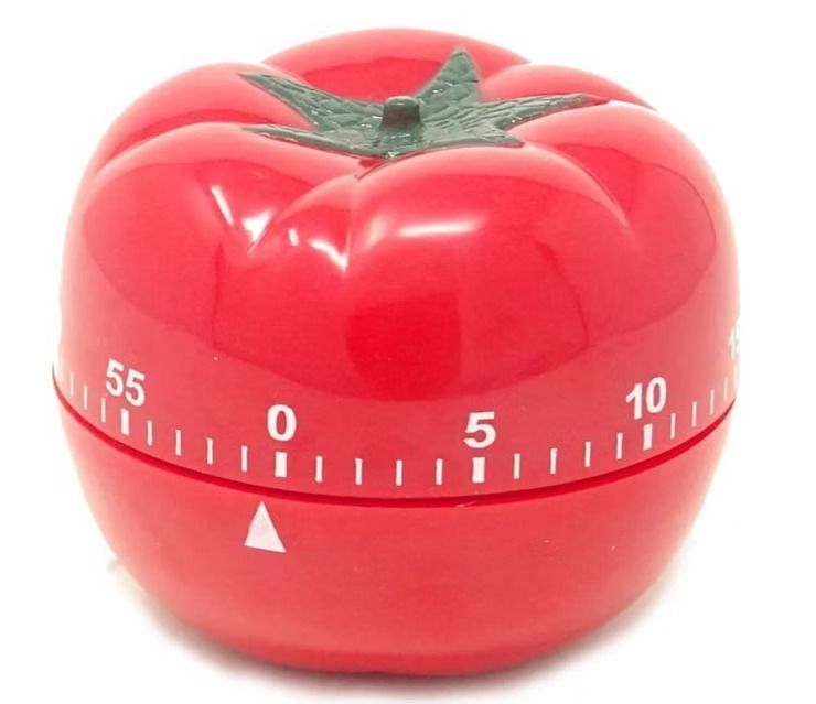 Red tomato-shaped kitchen timer with a green top, set at 0 minutes.