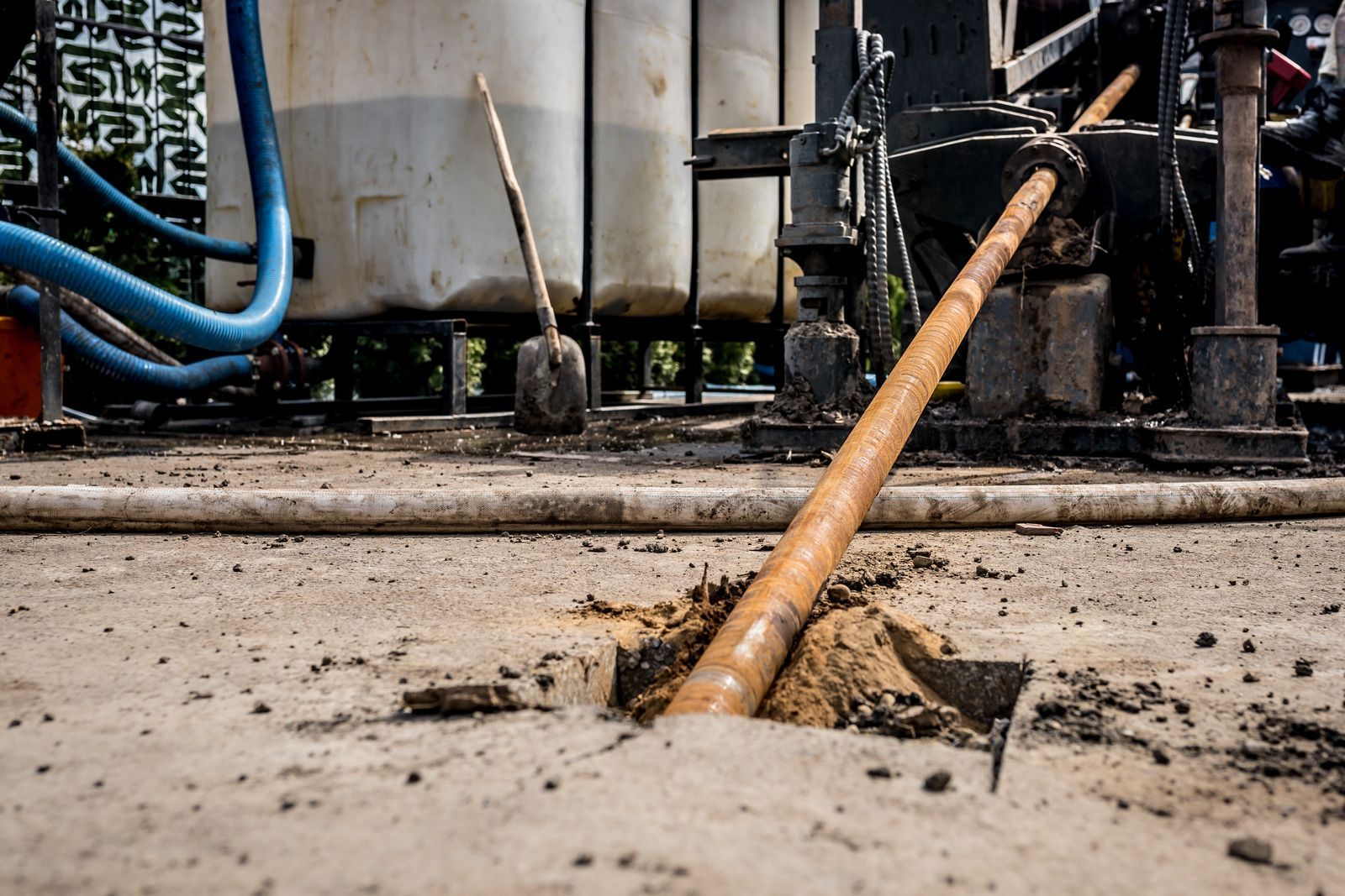 A pipe is sticking out of a hole in the ground.