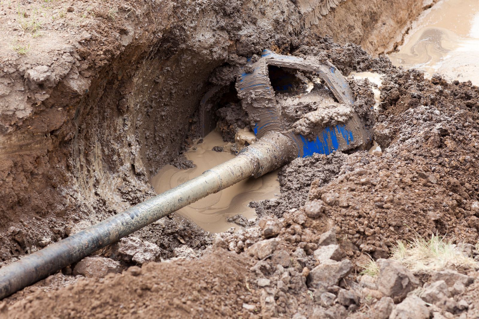 A pipe is sticking out of a hole in the ground.