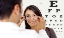 Doctor giving eye exam to a woman in Greensburg, IN