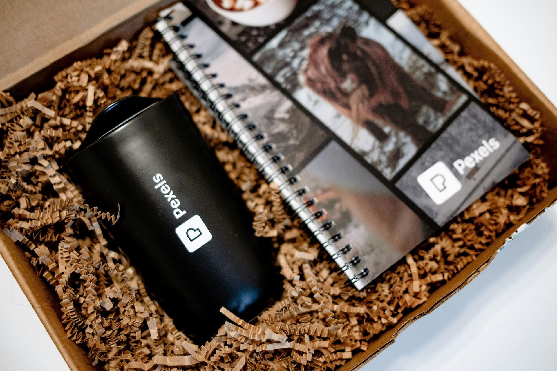 Custom kitting example with branded water bottle and notebook in protective packaging