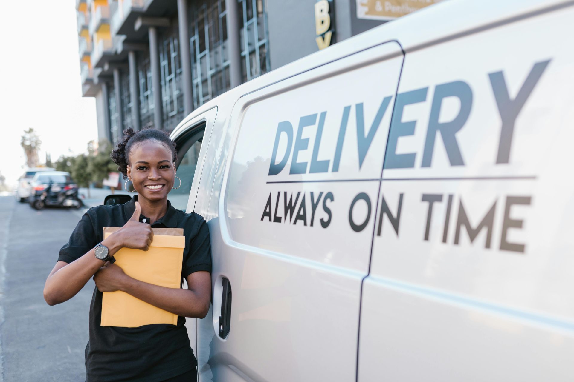 A delivery worker beside a van labeled “Delivery Always On Time,” showing reliable logistics.