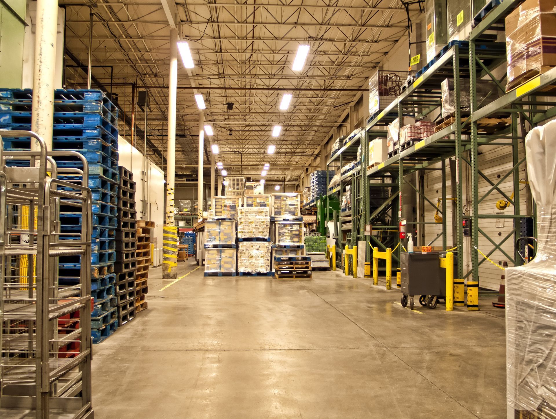 A large warehouse filled with lots of shelves and pallets.