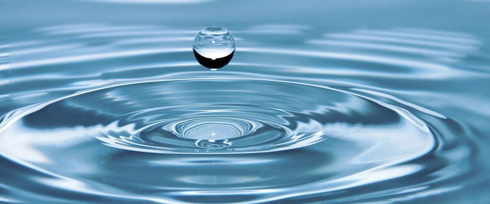 Round Water droplet falling in water