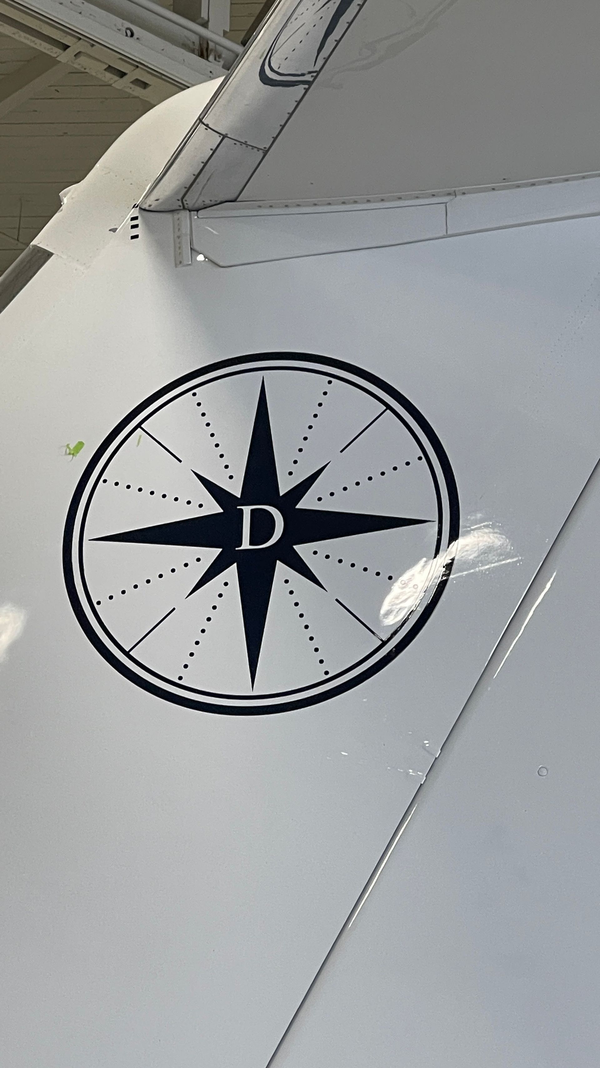 A compass with the letter d on it