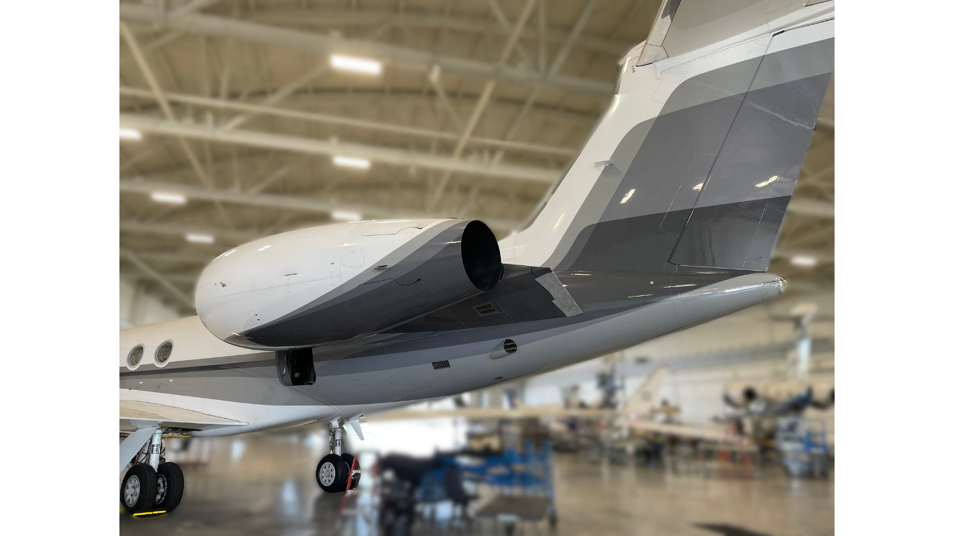 A small jet is parked in a hangar.