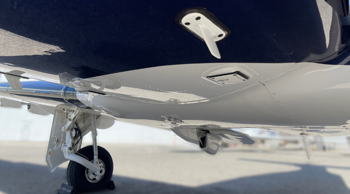 A close up of a plane 's landing gear on a runway.