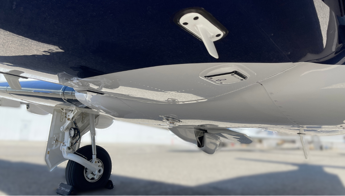 A close up of a plane 's landing gear on a runway.