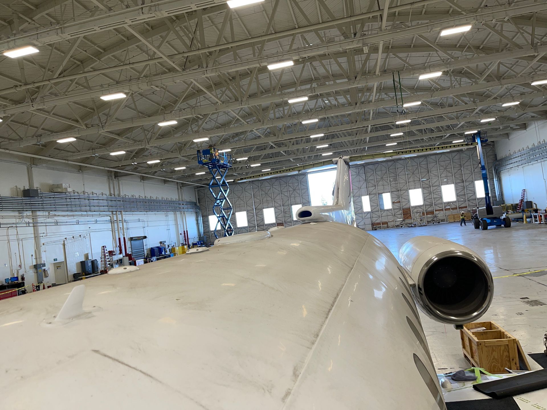 A plane is being built in a large hangar.