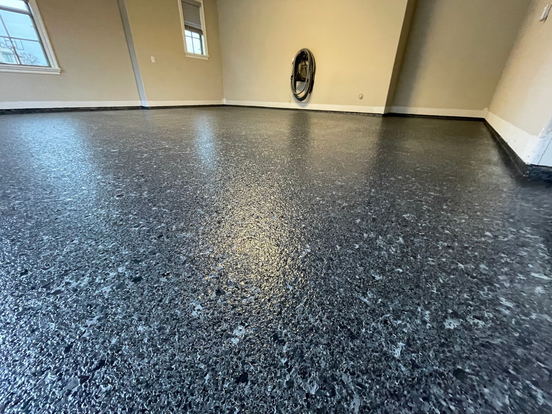 A close up of a black concrete floor in a garage.