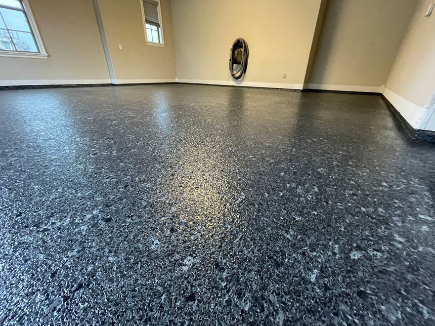 A close up of a black concrete floor in a garage.