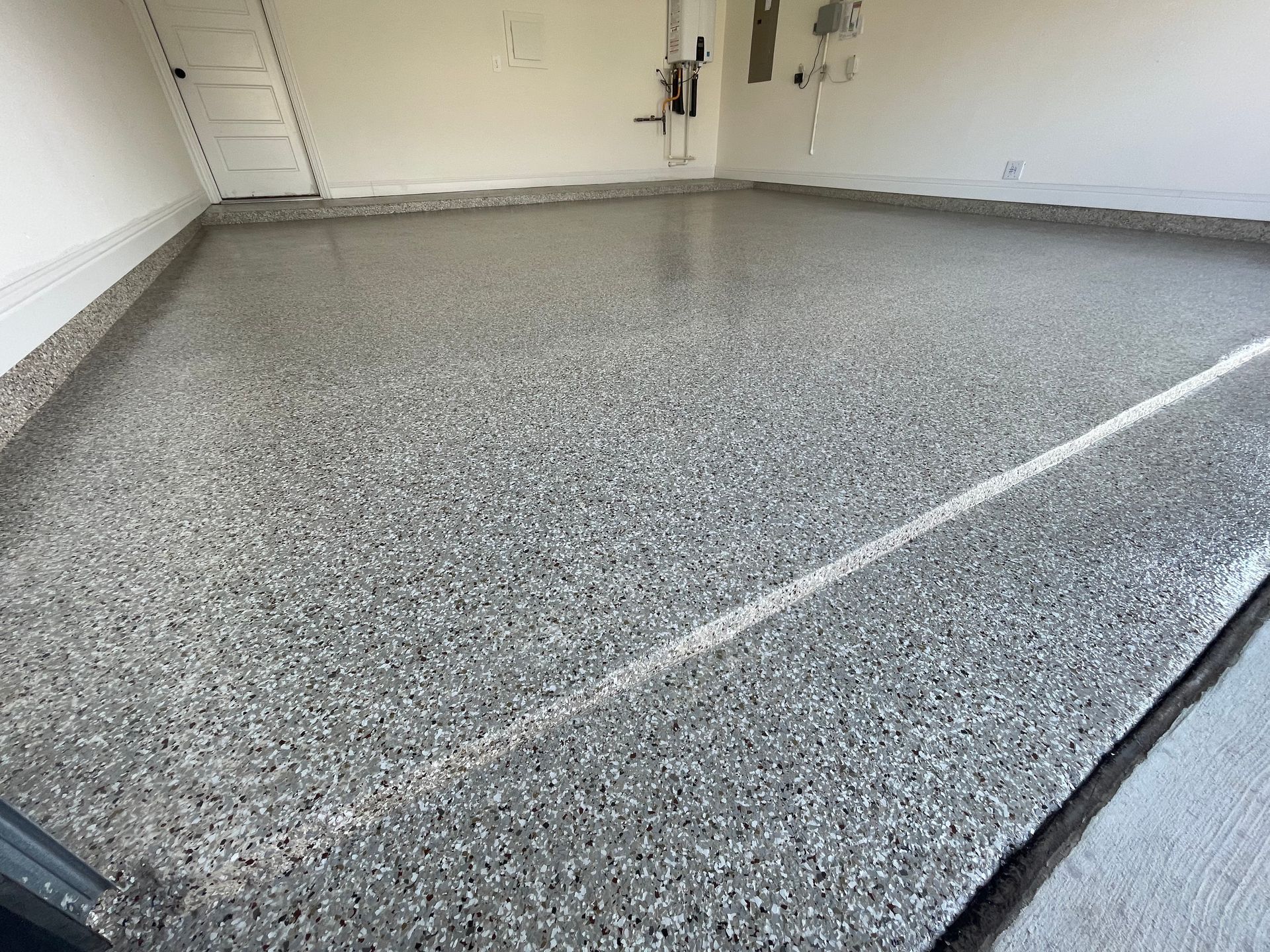 A garage floor with a lot of small stones on it.