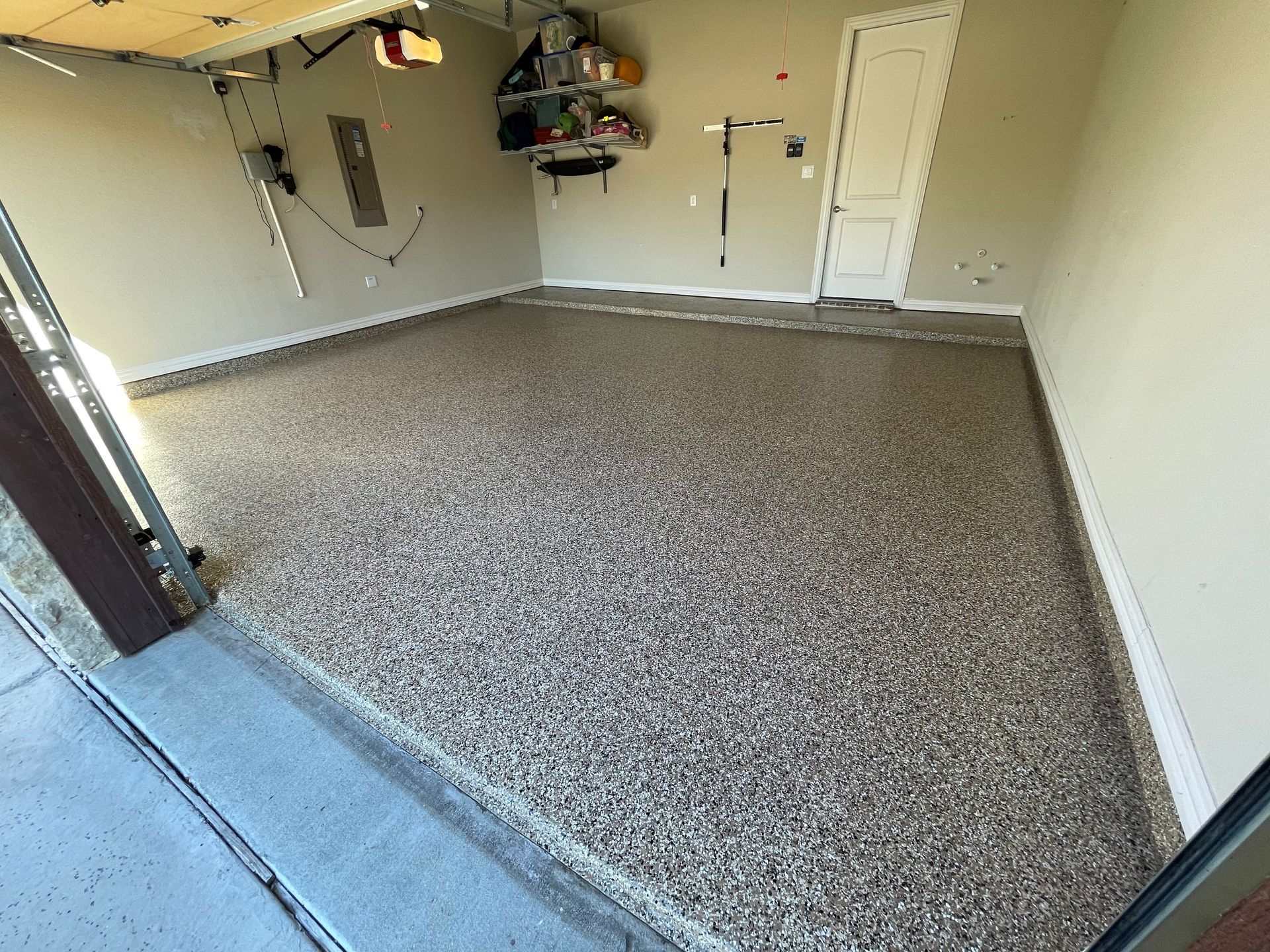 A garage with a concrete floor and a garage door.