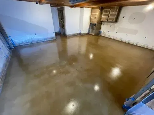 A room with a concrete floor and white walls.