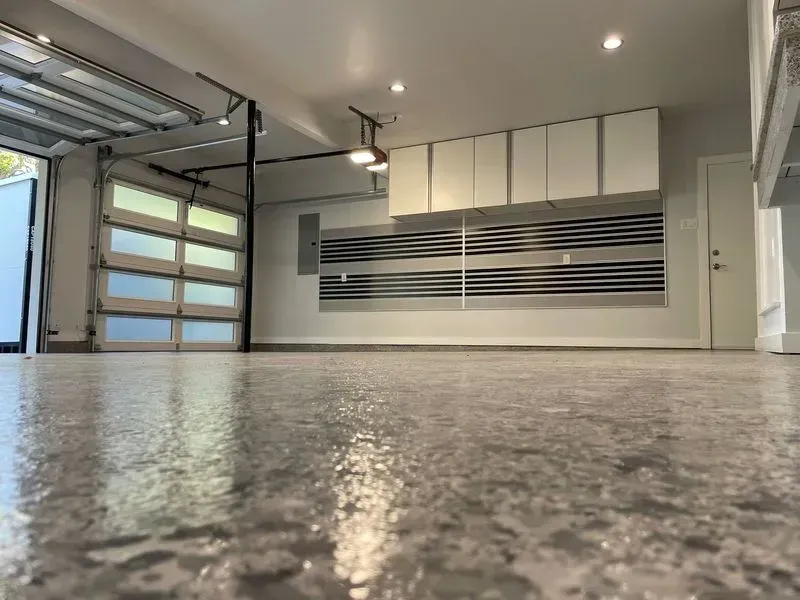 A garage with a concrete floor and a garage door.