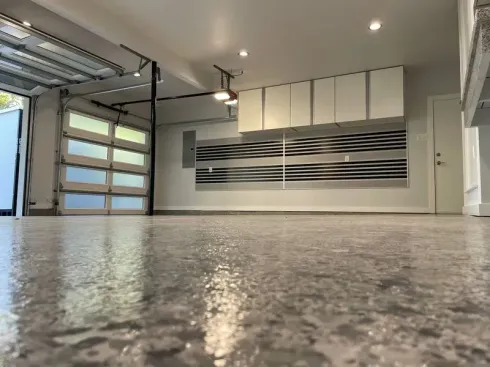 A garage with a concrete floor and a garage door.