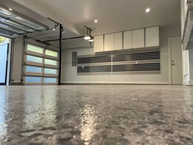 A garage with a concrete floor and a garage door.