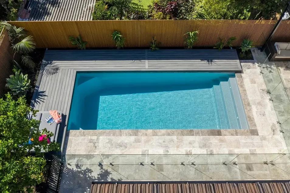 An aerial view of a swimming pool in a backyard
