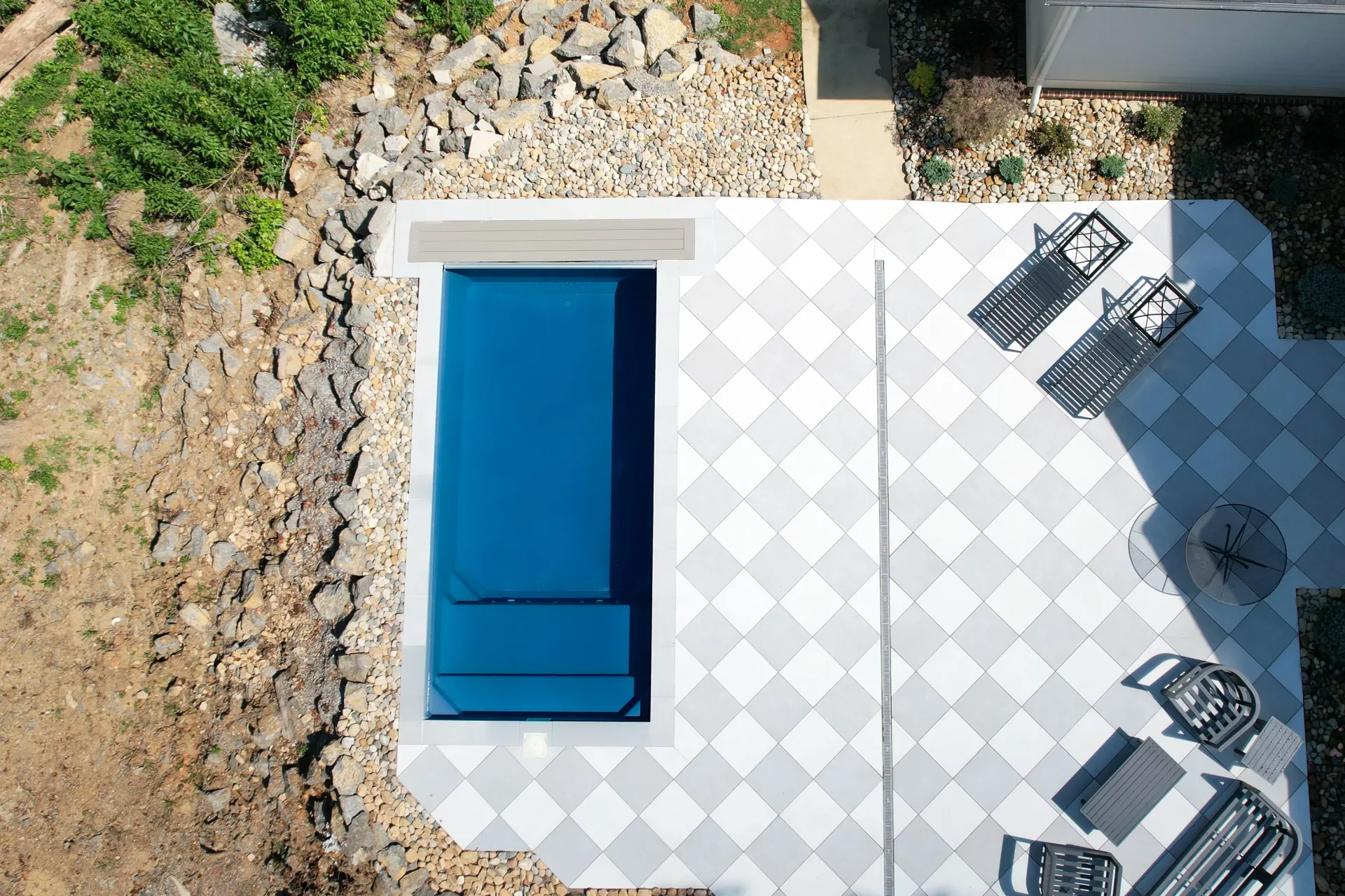 An aerial view of a patio with a blue couch and chairs.