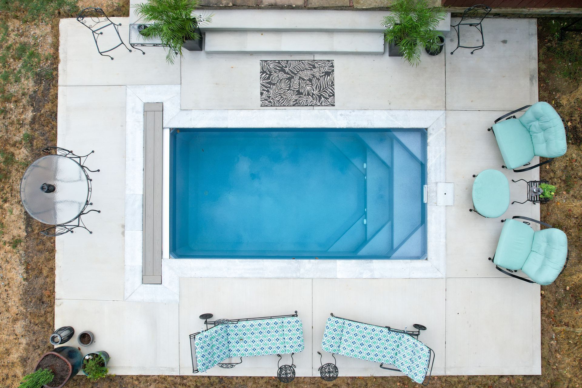 A large house with a large swimming pool in front of it.