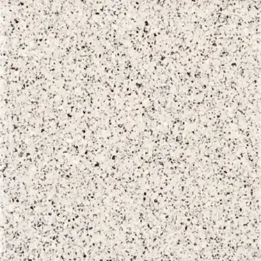 A close up of a white tile with black spots