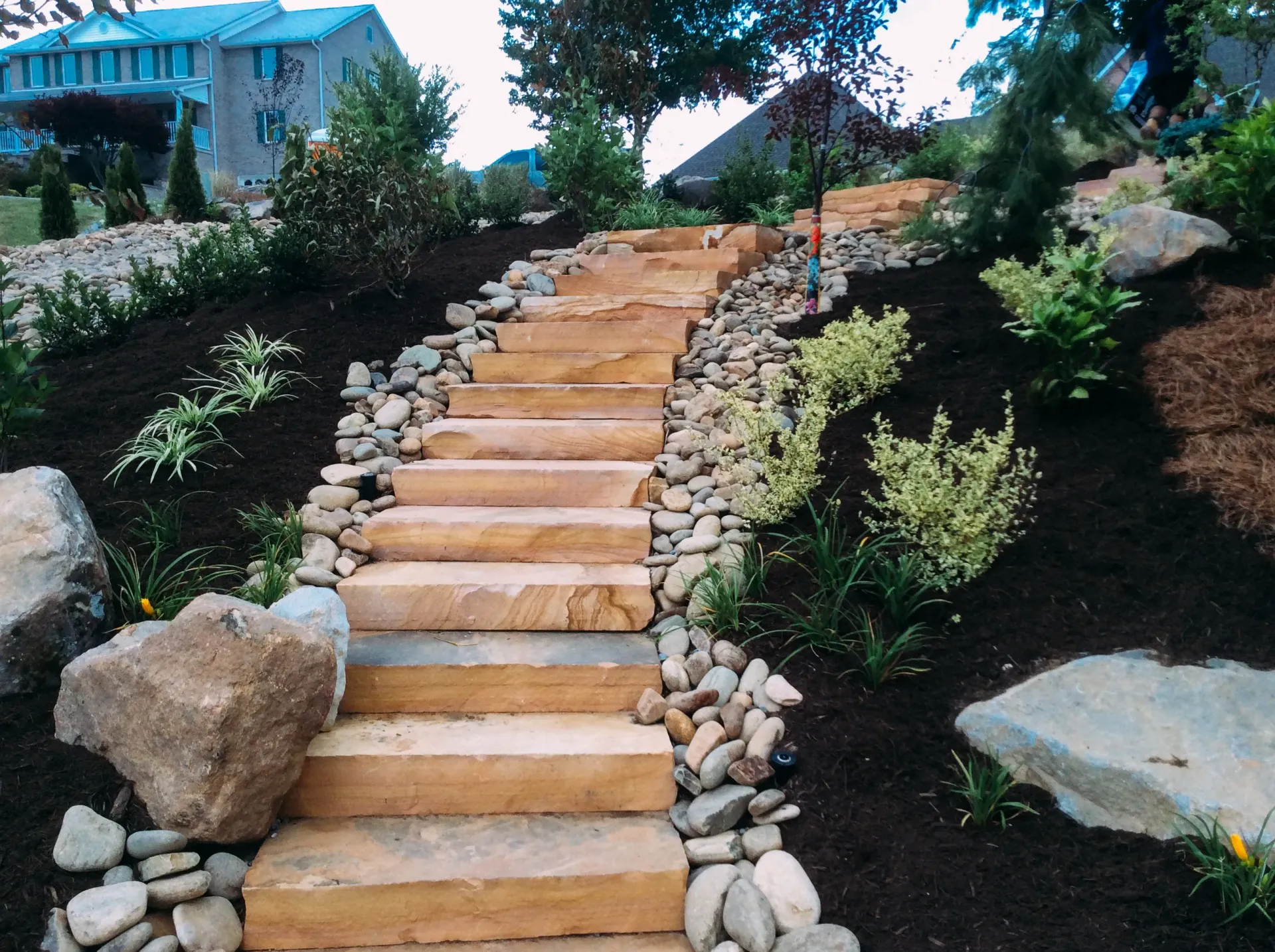 A set of wooden stairs leading up to a house