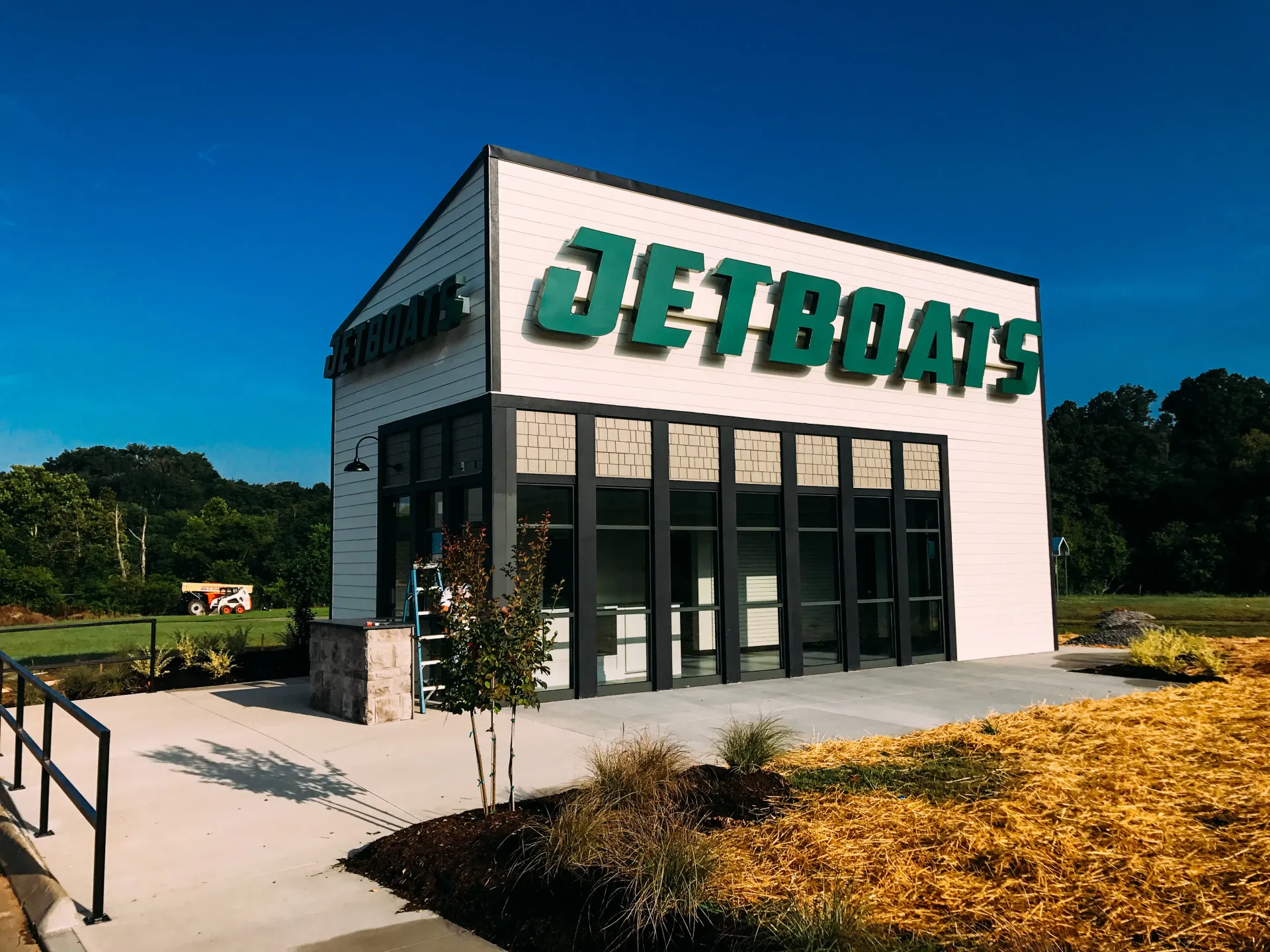 A white building with green letters that says jetboats