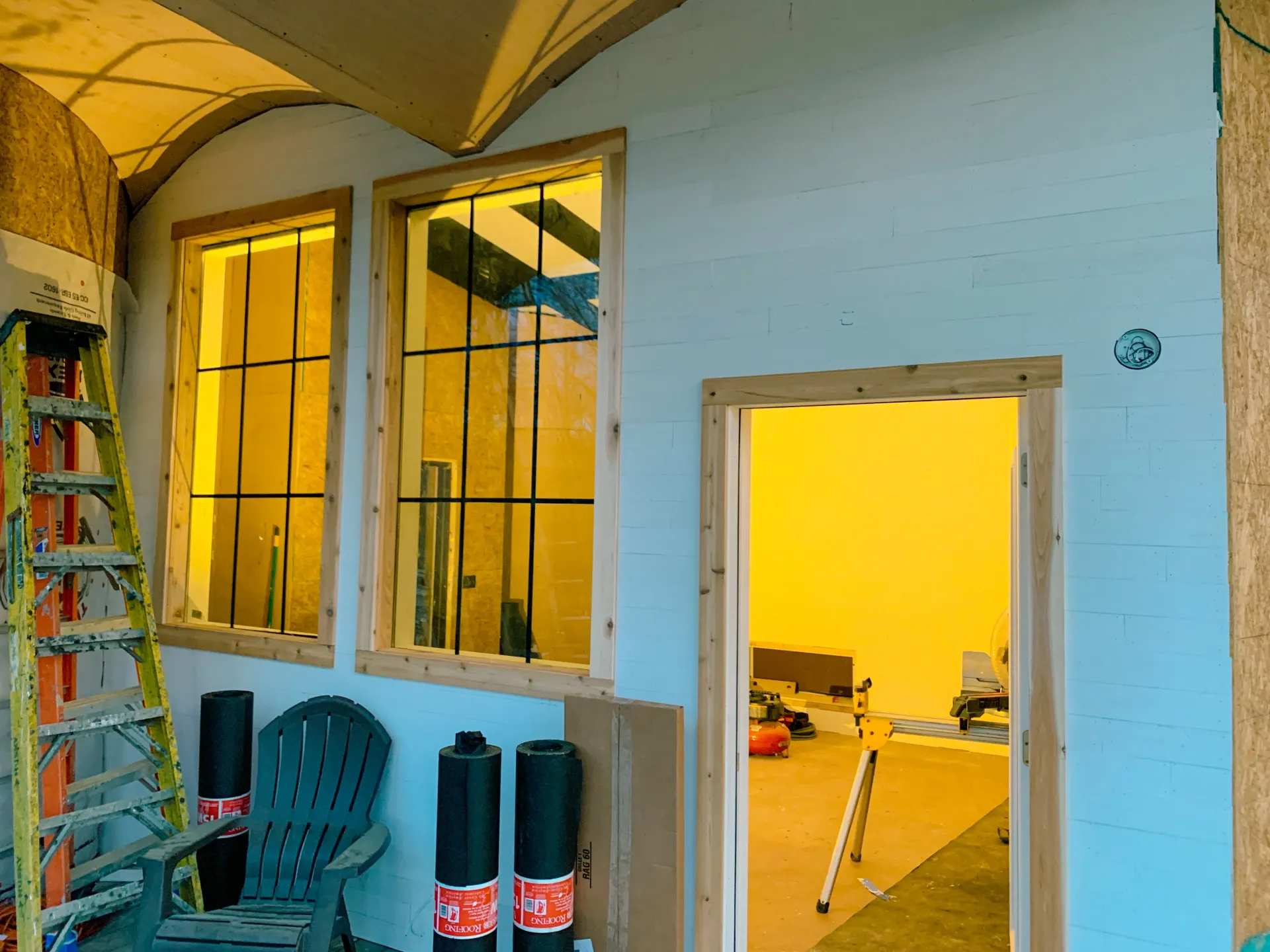 Framed doorway and tall windows during she shed construction phase