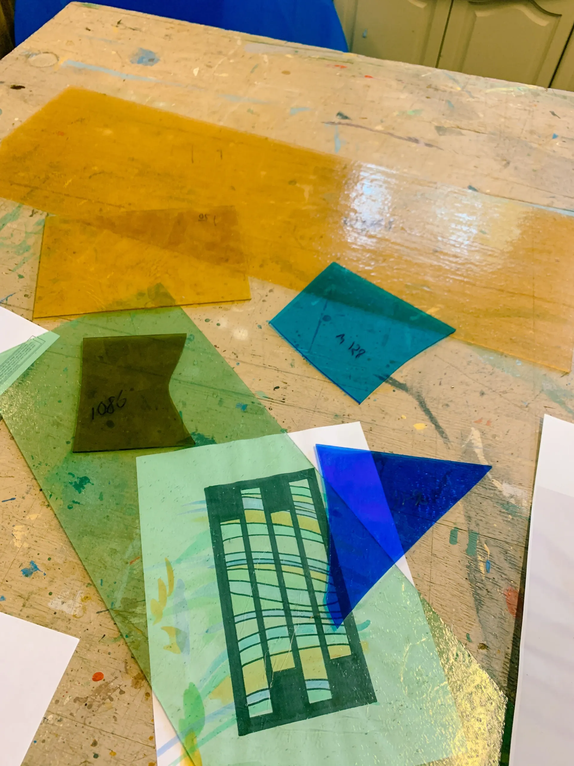 Cut glass samples and design sketch for custom stained glass window feature