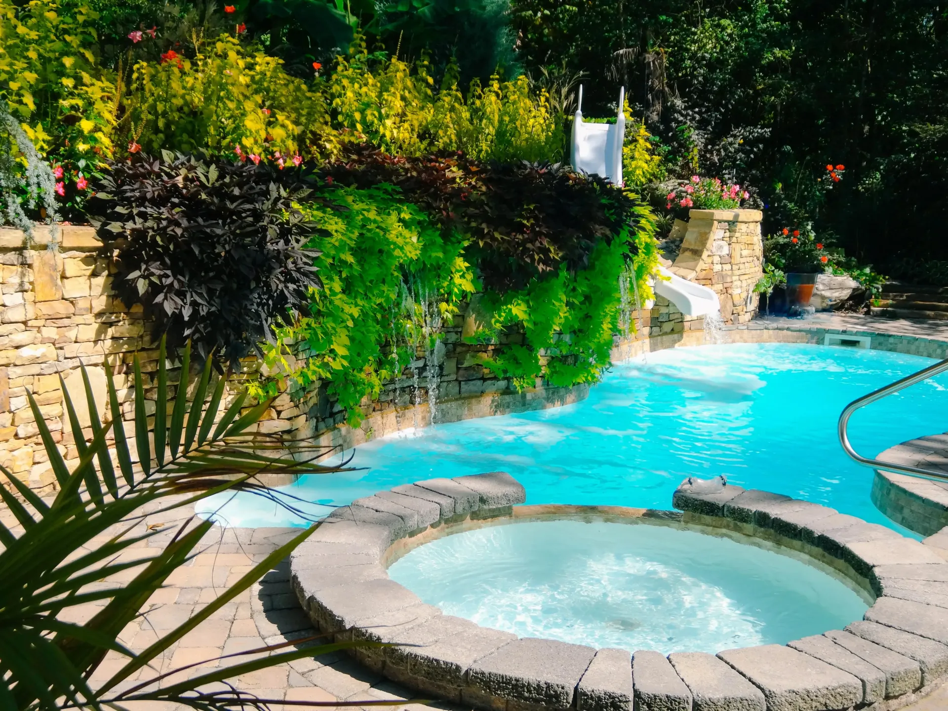 A swimming pool with a hot tub in the middle