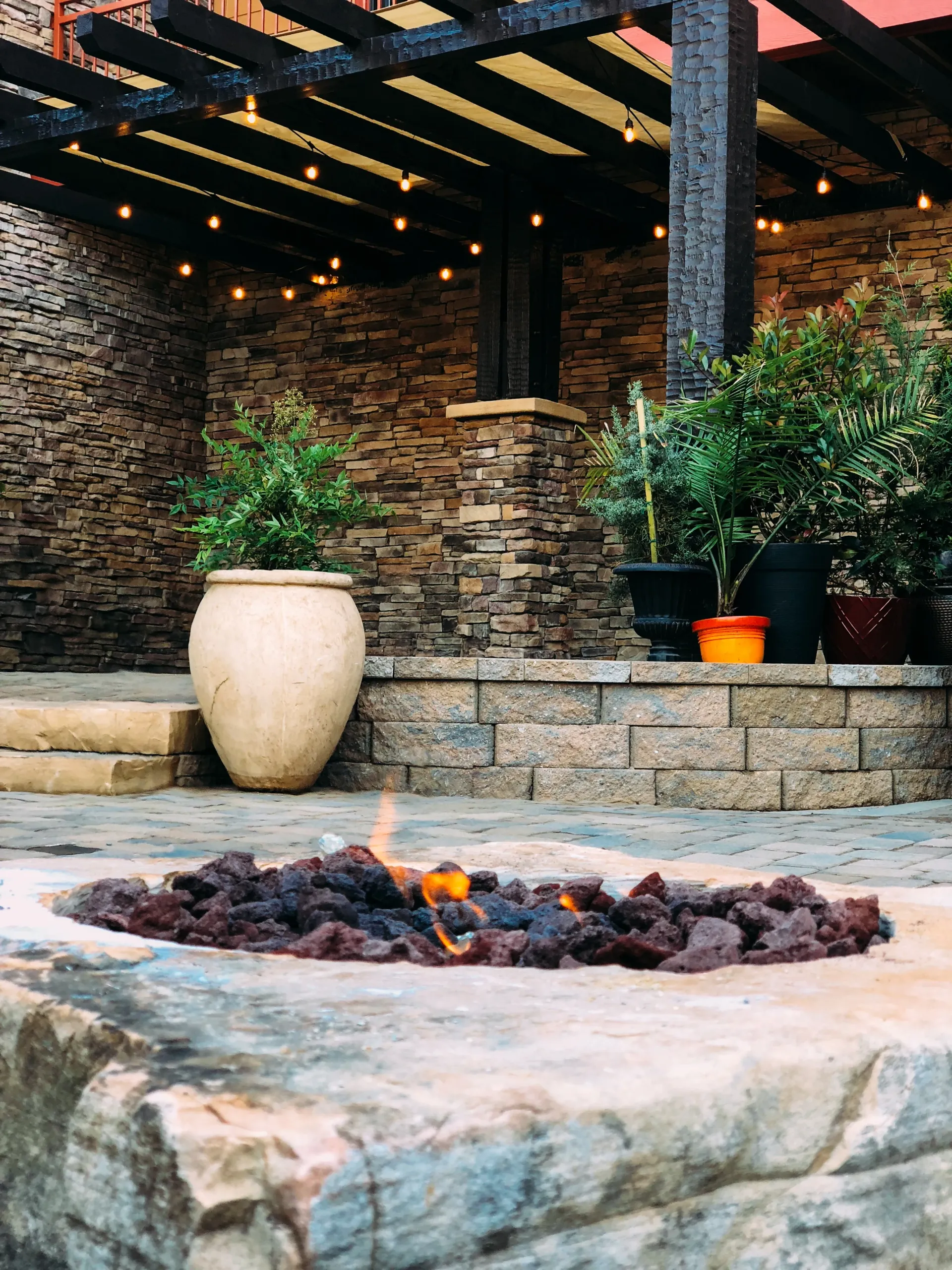 There is a fire pit in the middle of the patio.