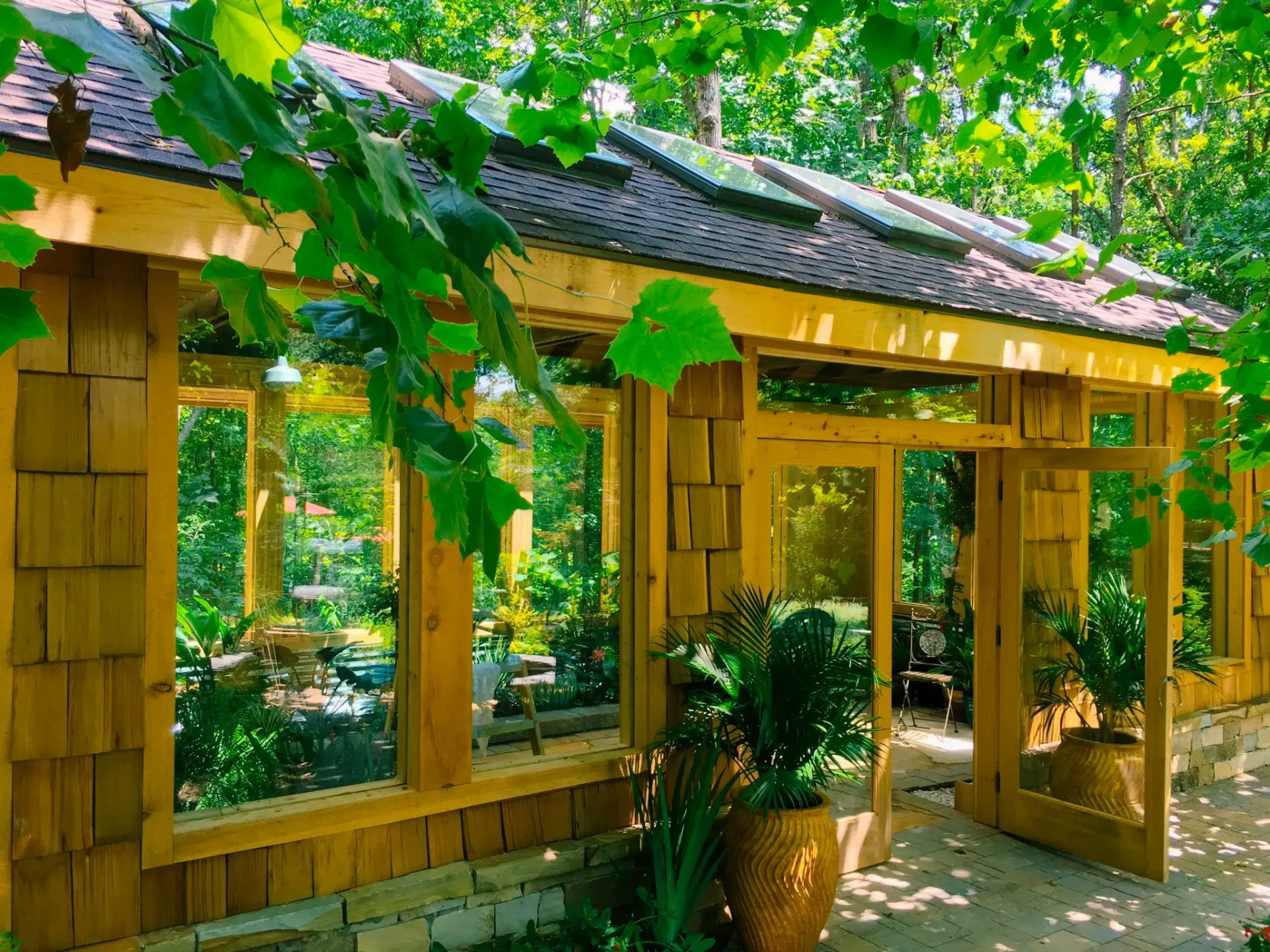 Custom-built sunroom with cedar shake siding and full wall of windows