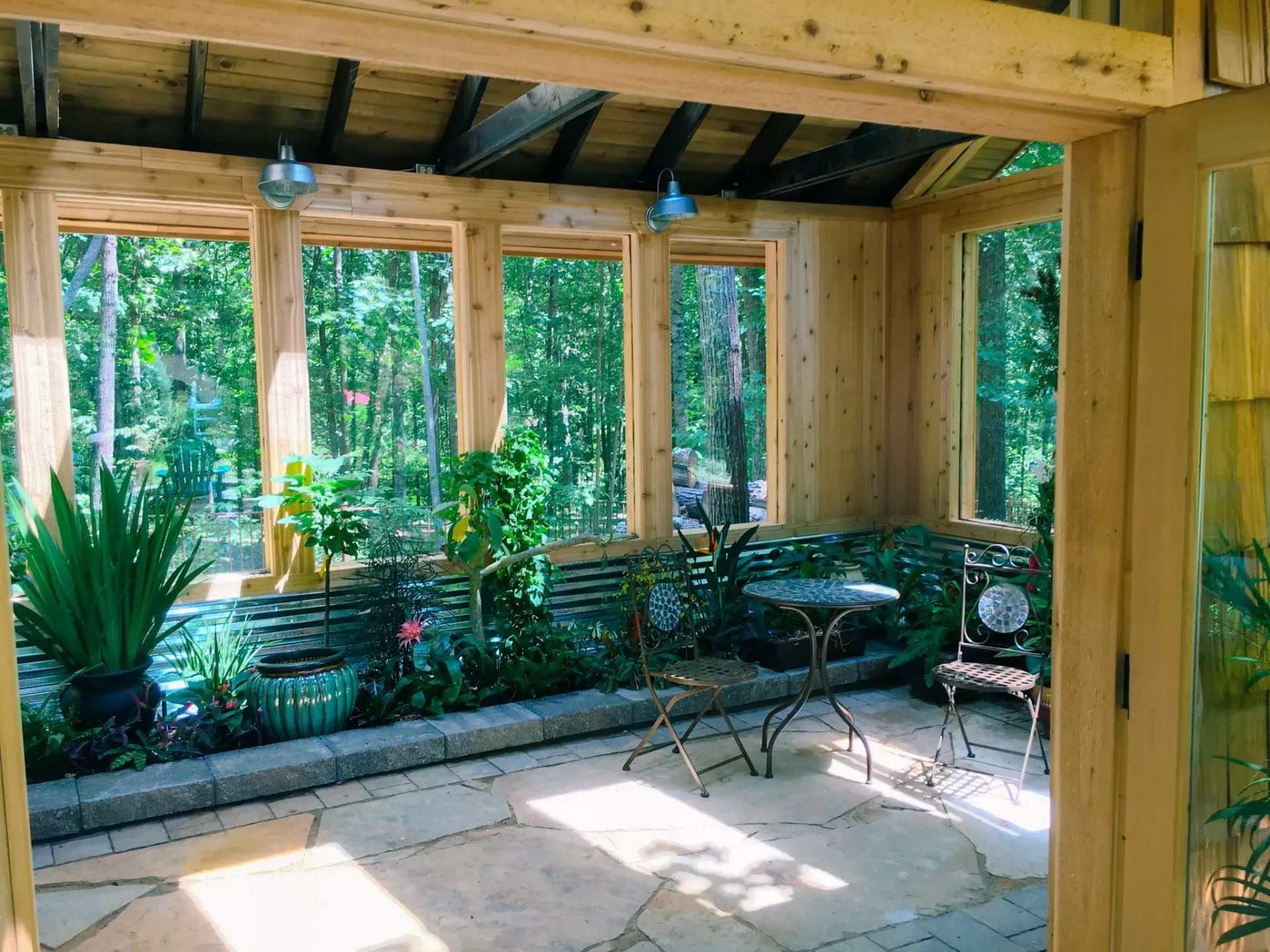 A room with a table and chairs and lots of windows
