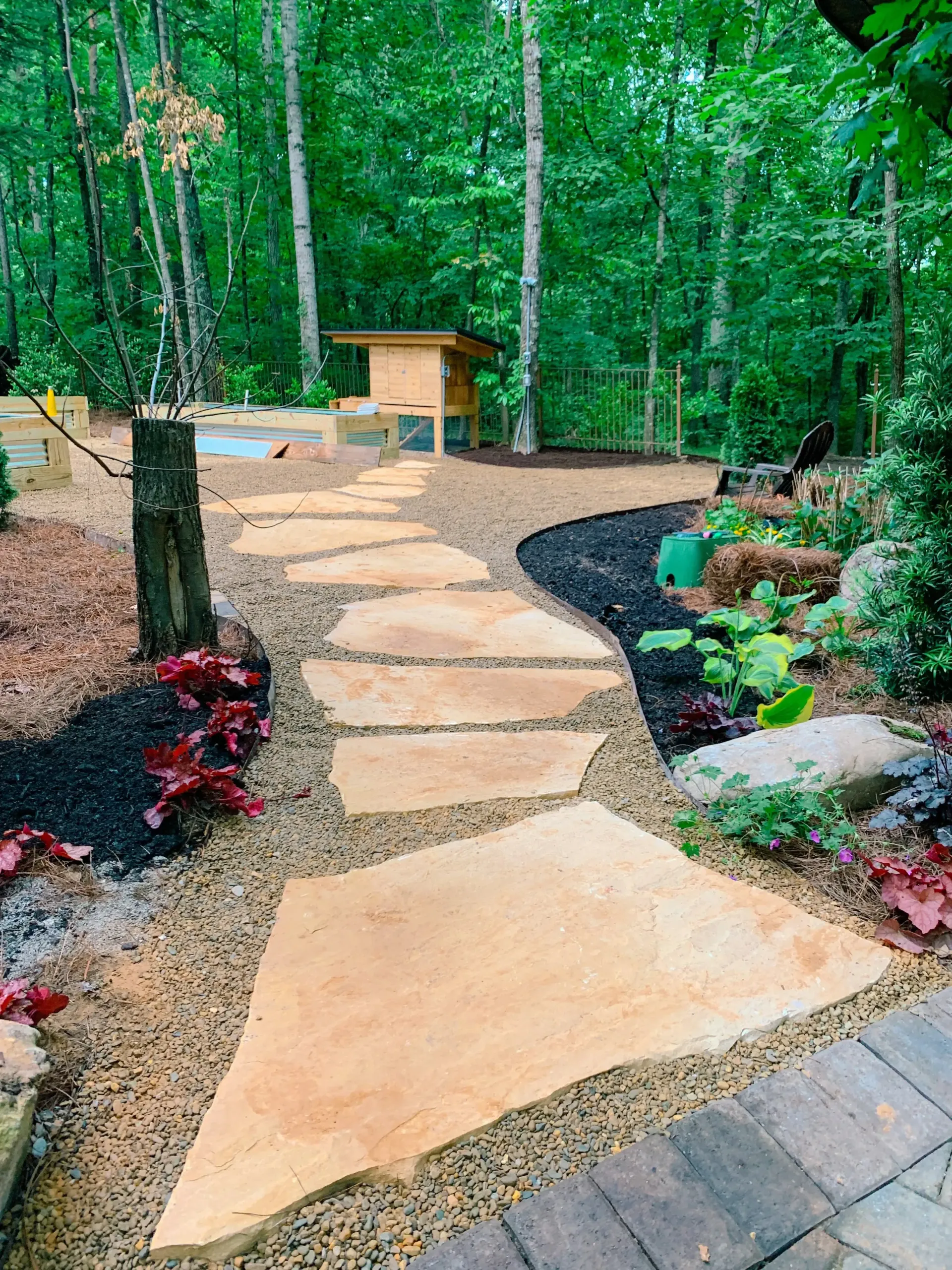 Flagstone garden path leading to custom backyard structure in East Tennessee